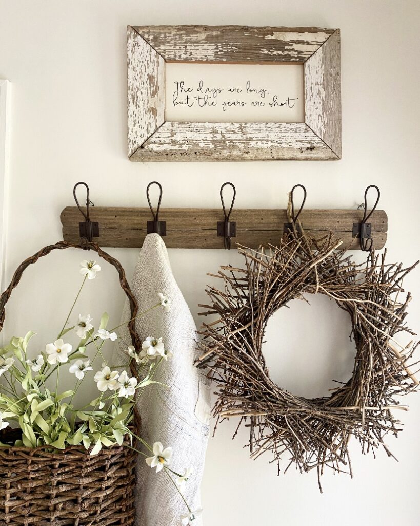 Farmhouse rack with wreath, grain sack and basket of faux flowers