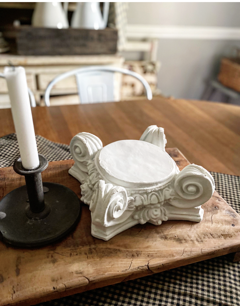 Painted white base on a wood riser with an old candle holder