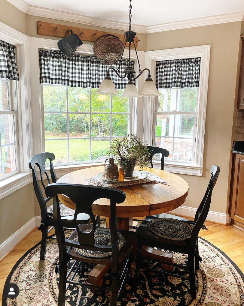 kitchen table nook with a peg rack.  It has a pitcher and basket hanging off it