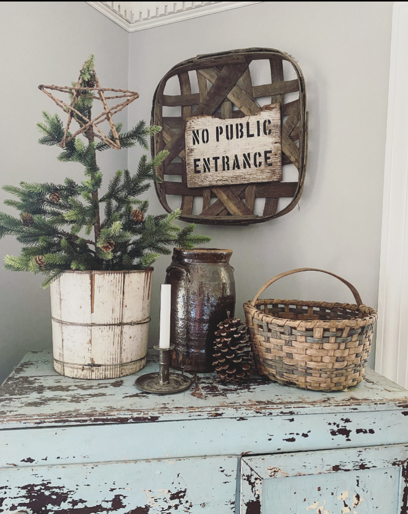 thrifted basket with a pinecone and other Christmas items
